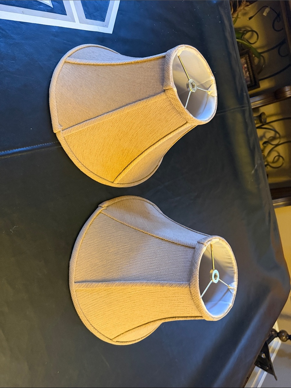 A matching pair of tan colored lamp shades